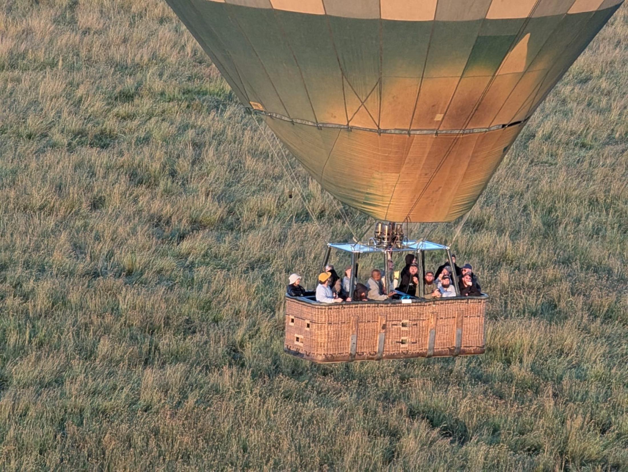 Hot air balloon floating over the Serengeti during a Soul-O adventure