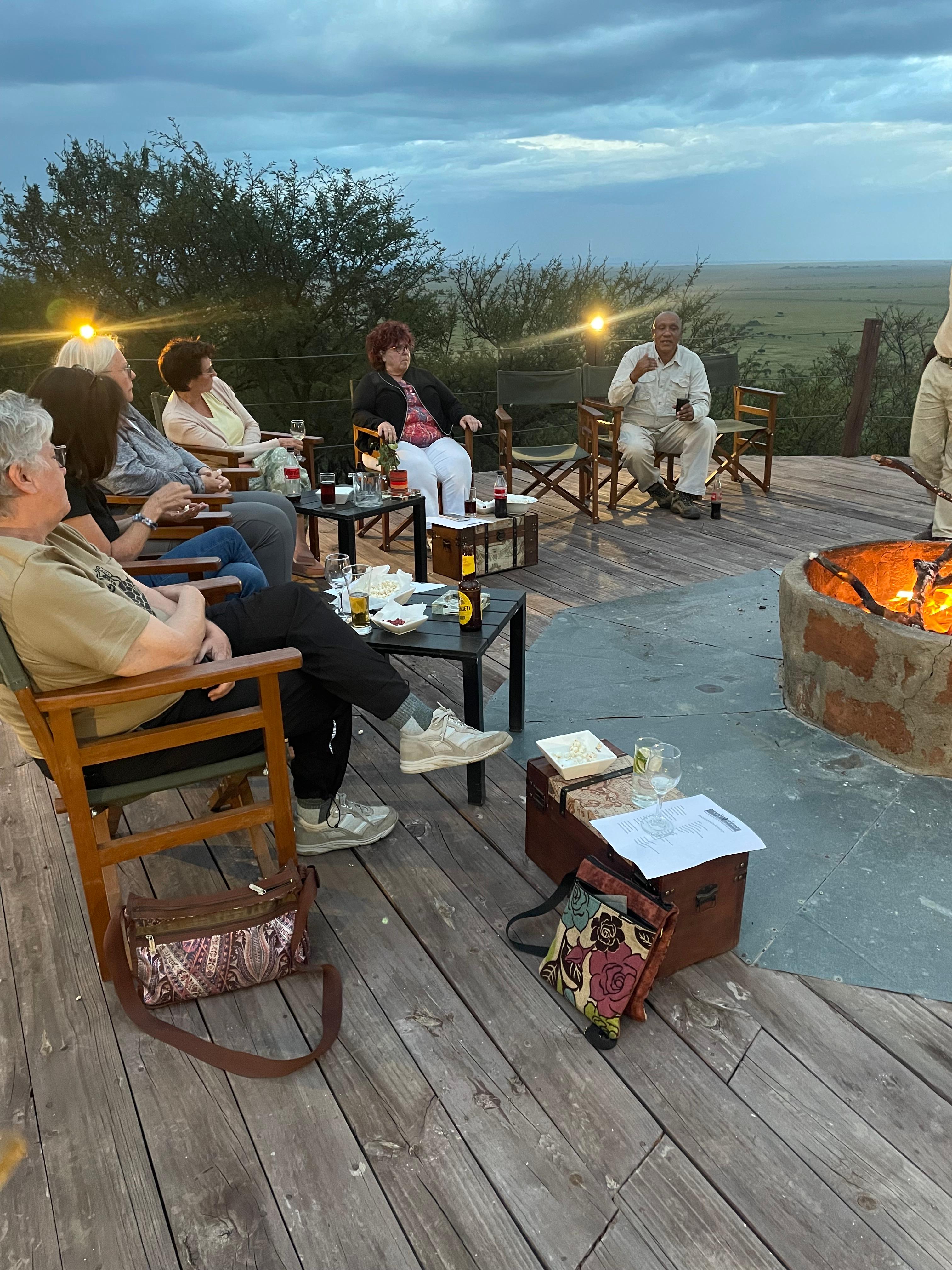 Soul-O travelers relaxing by an evening fire overlooking the plains